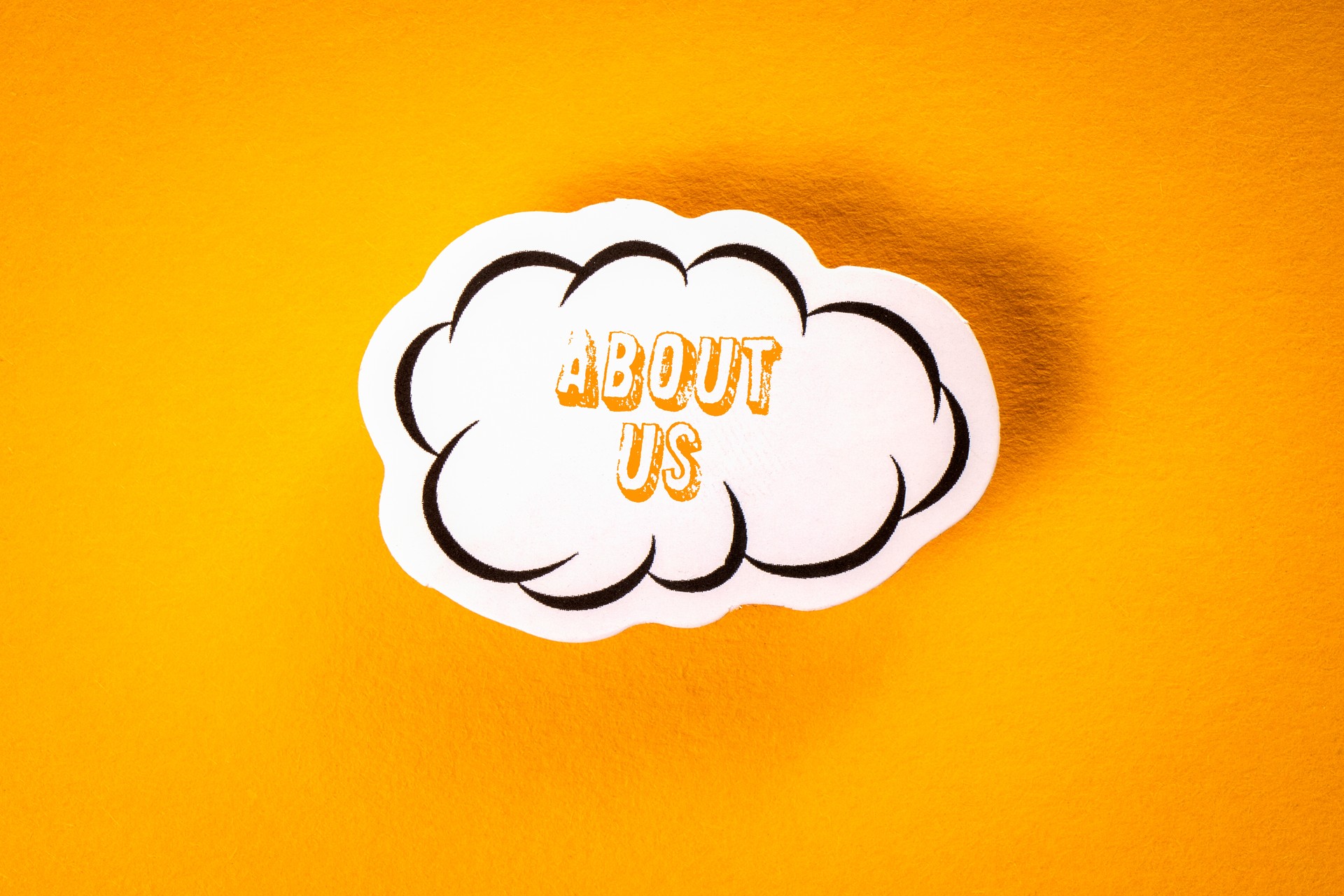 About Us. Text with speech cloud on yellow background